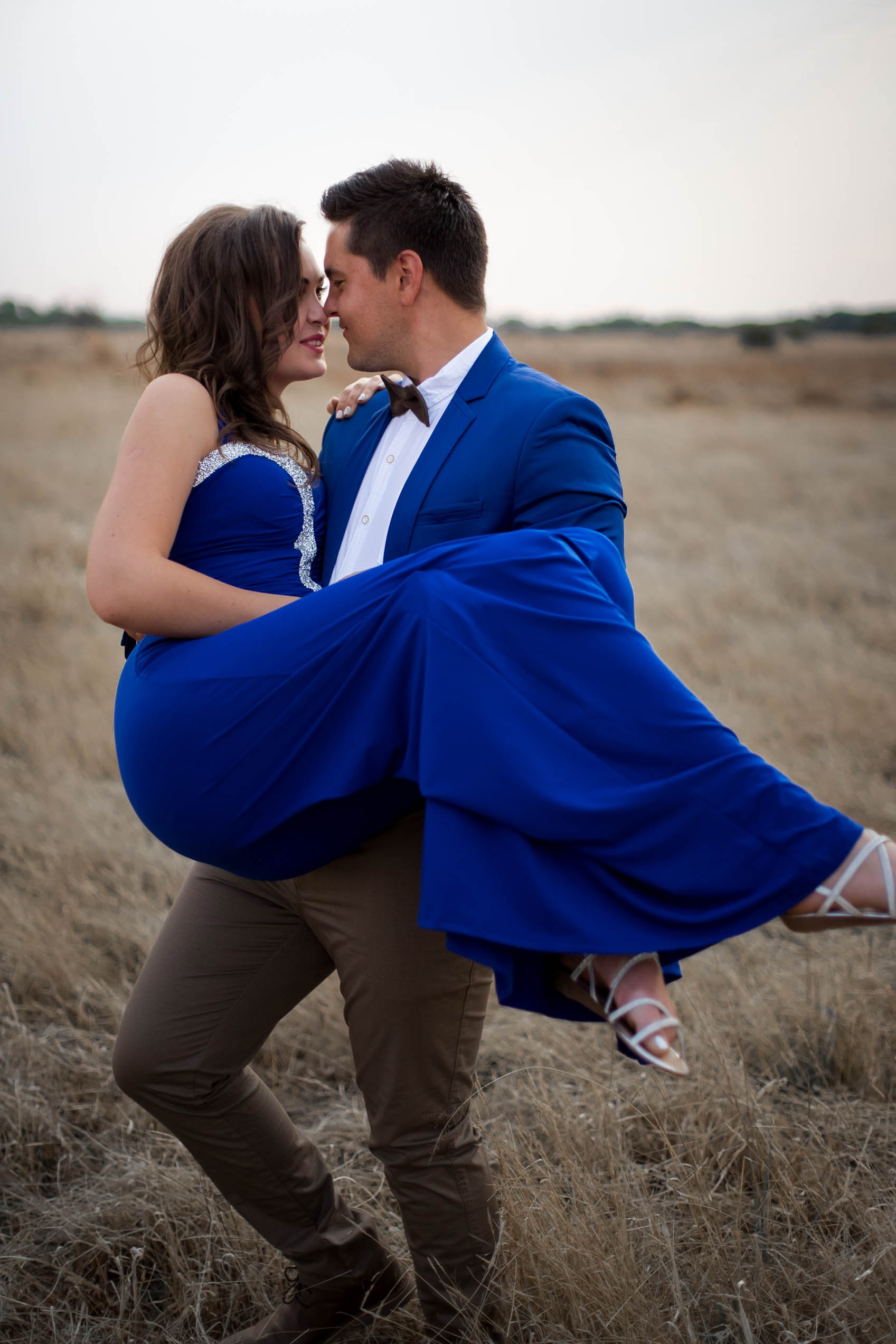 couple in field blue dress