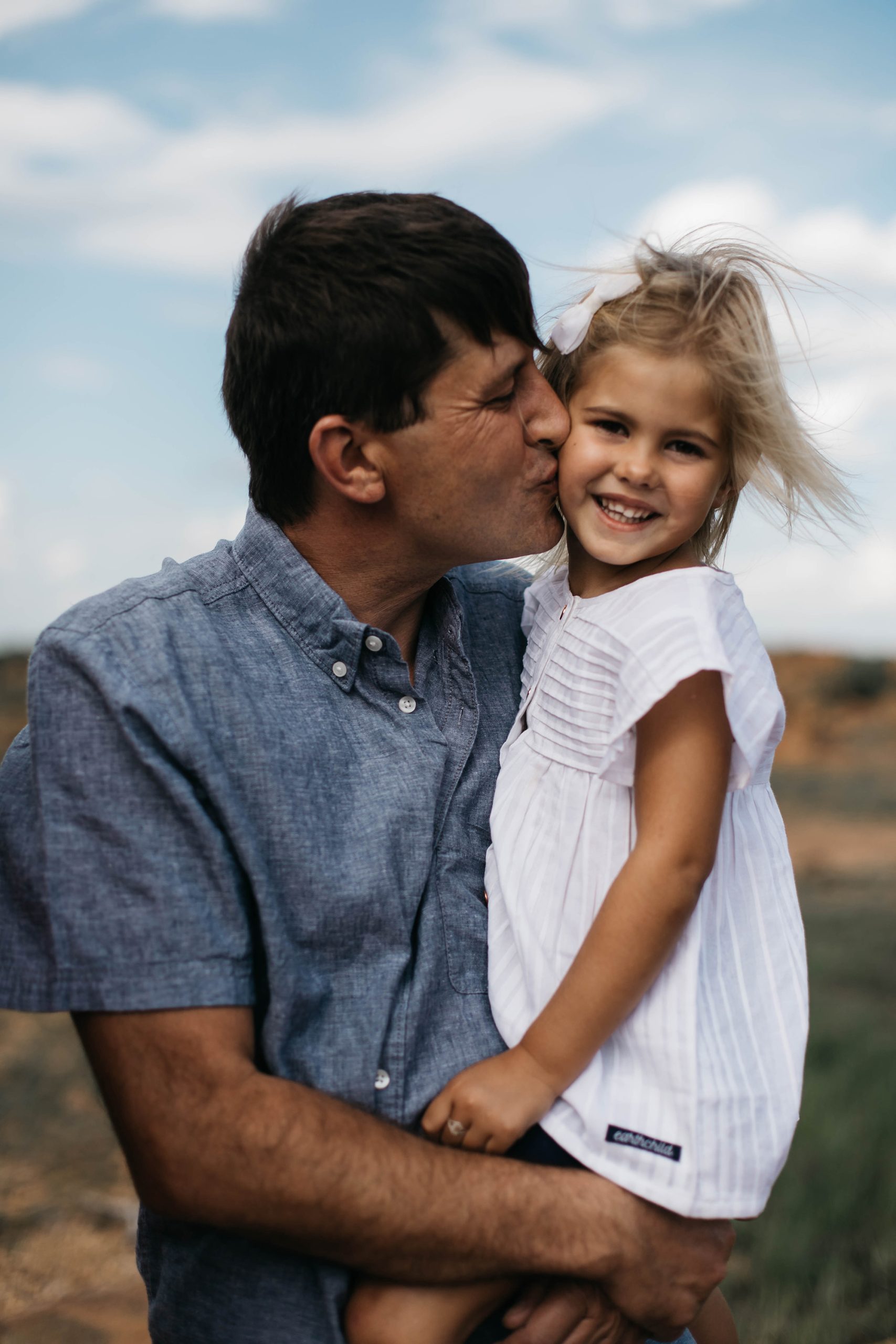 dad carrying daughter
